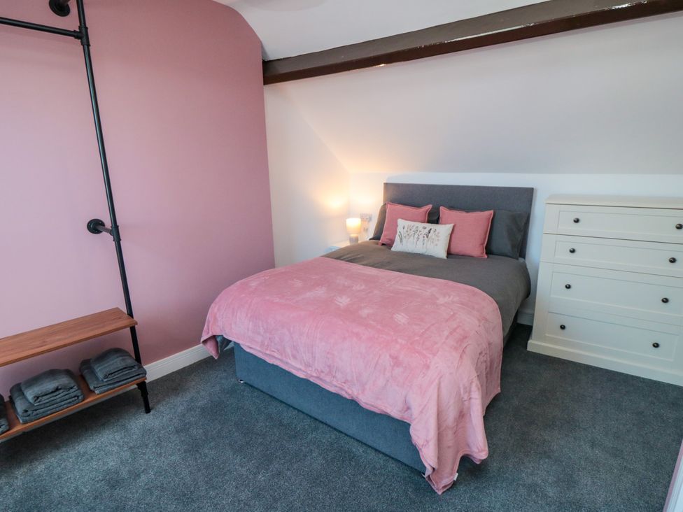 A bedroom with a bed and dresser at Portobell House in Bridlington