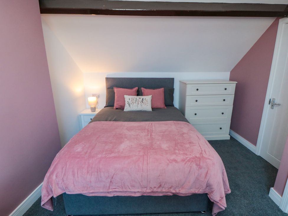 A bedroom with a bed and a chest of drawers at Portobell House in Bridlington