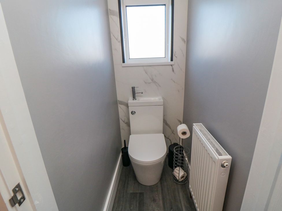 A bathroom with a toilet and radiator at Portobell House in Bridlington