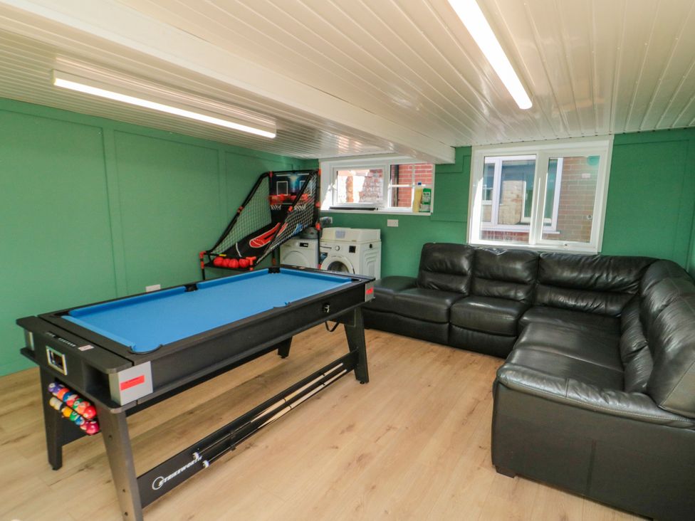 A game room with a pool table and sofa at Portobell House in Bridlington