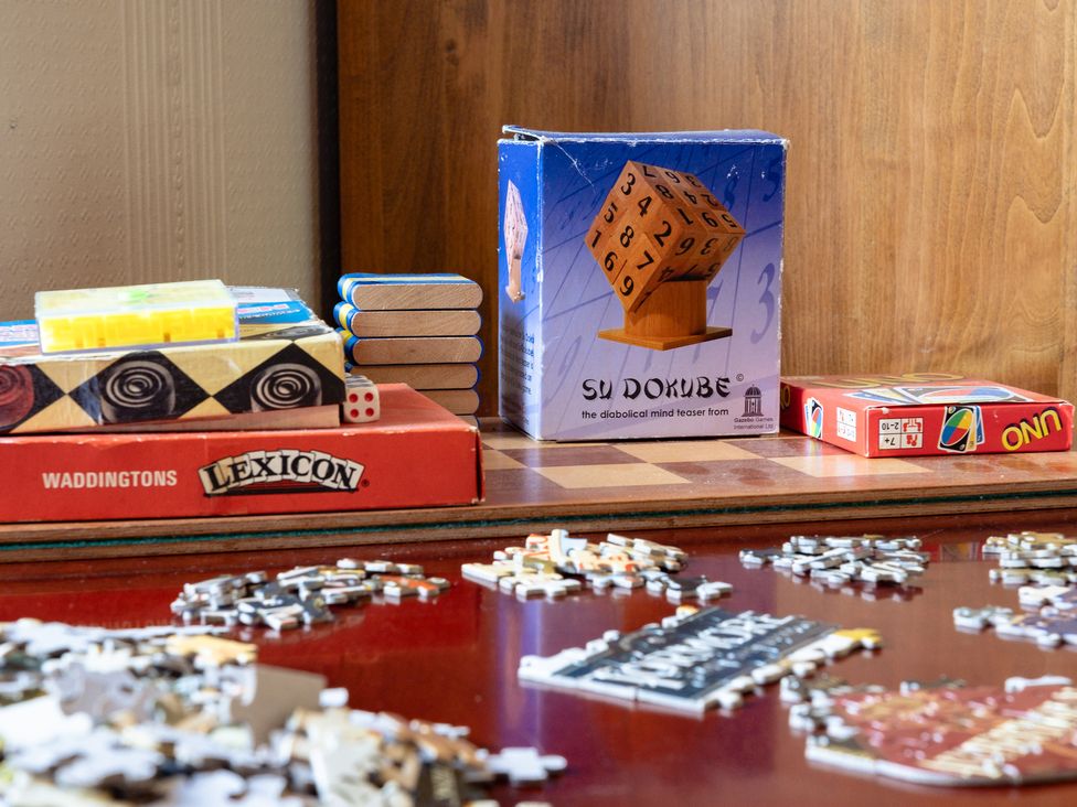 A collection of board games and puzzle pieces at Curlew Cottage in Crianlarich