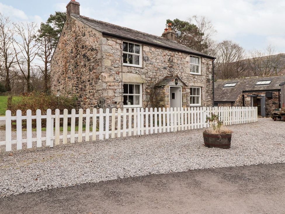 A house with a white fence and gravel pathway at Irt Cottage in Seascale