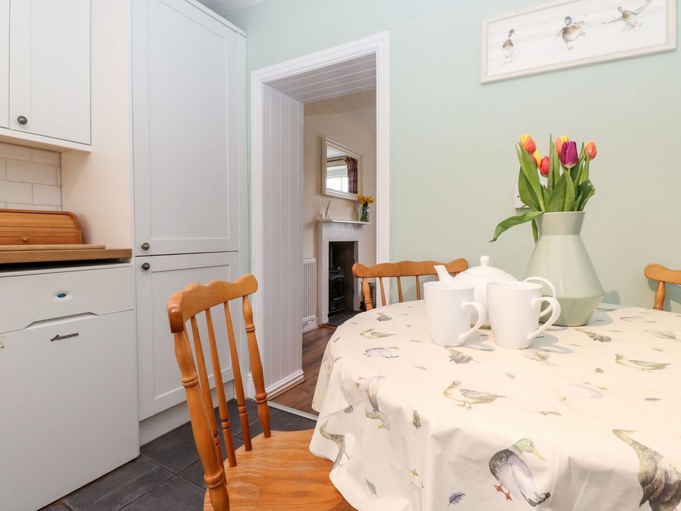 A kitchen with a table and chairs at Irt Cottage in Seascale