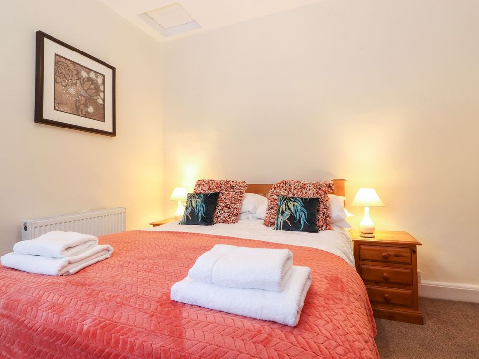 A bedroom with a bed and bedside table at Irt Cottage in Seascale