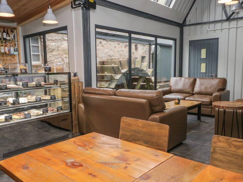 A cafe with couches and a display case at Irt Cottage in Seascale