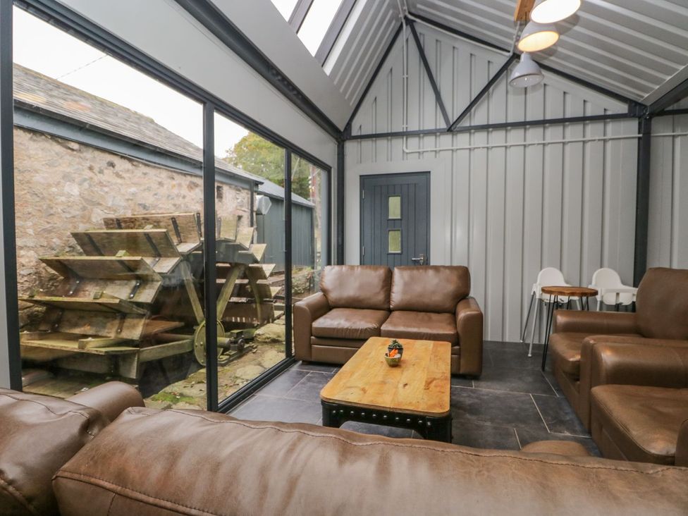 A snug with a coffee table and sofas at Irt Cottage in Seascale