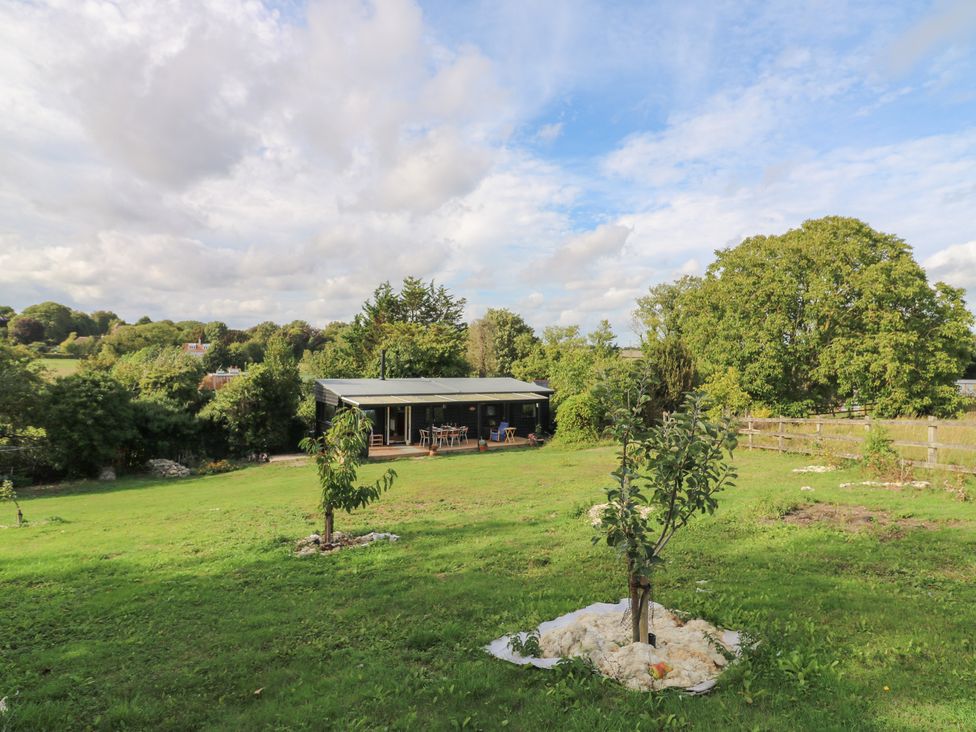 An outdoor view of a house with tables and chairs at Orchard Lodge in Dover