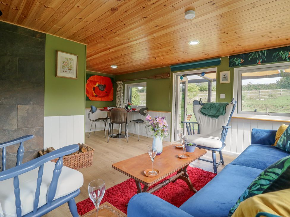 A living room with a sofa and table at Orchard Lodge in Dover