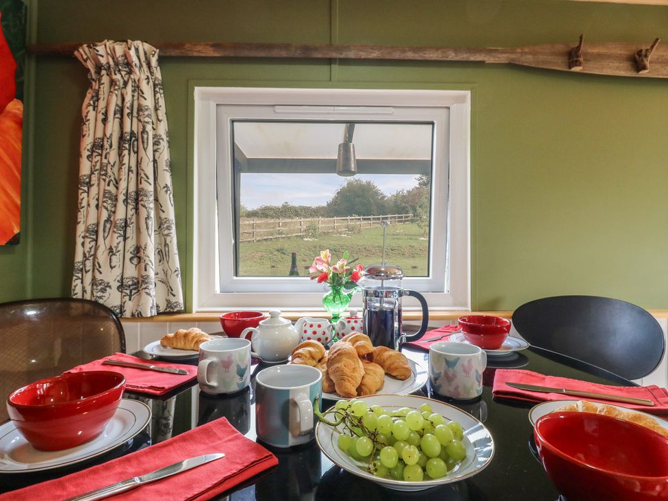 A kitchen table set for breakfast with food and drinks at Orchard Lodge in Dover