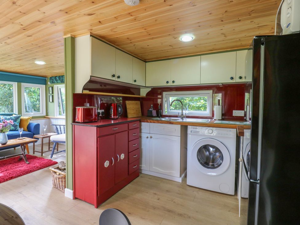 A kitchen with cabinets and appliances at Orchard Lodge in Dover