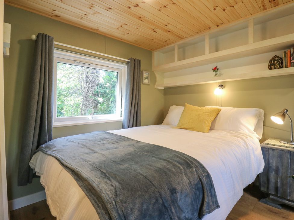 A bedroom with a bed and window at Orchard Lodge in Dover