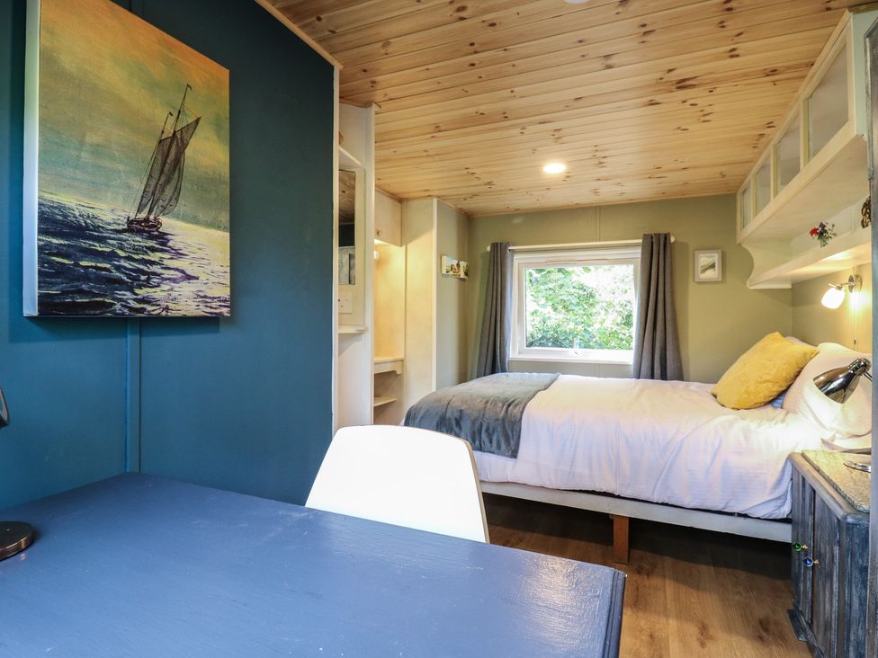A bedroom with a bed and desk at Orchard Lodge in Dover