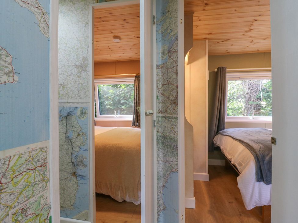 A bedroom with two beds and a window at Orchard Lodge in Dover