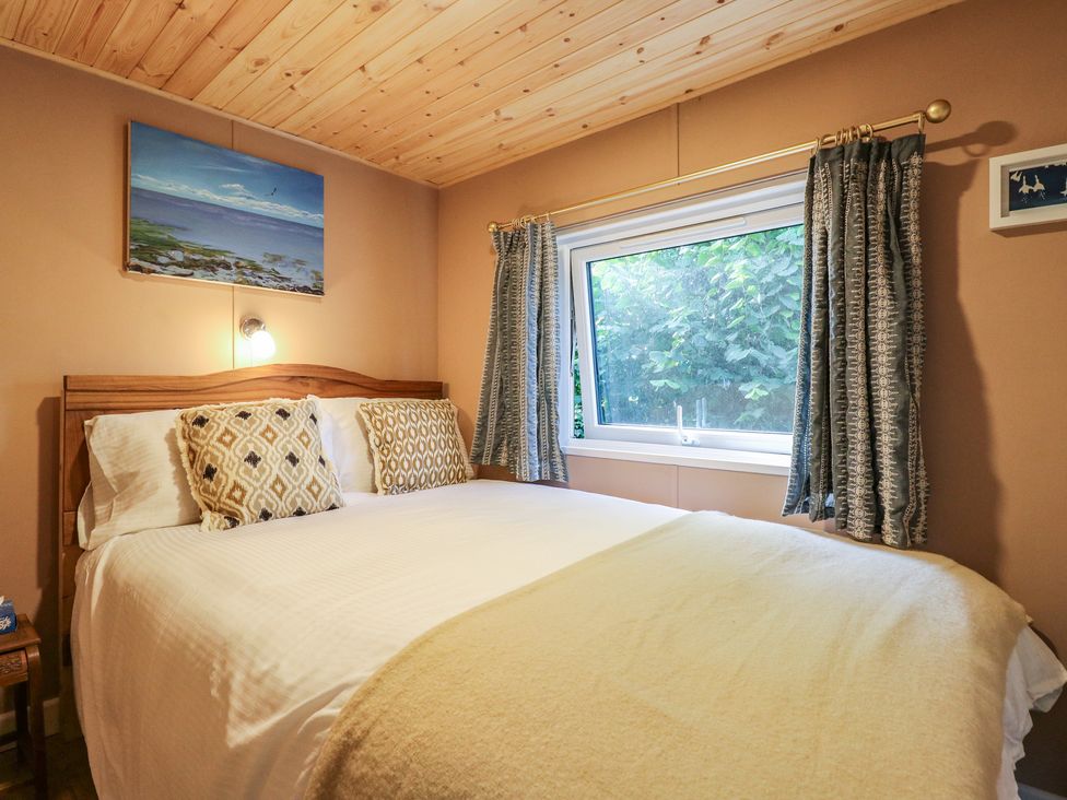 A bedroom with a bed and window at Orchard Lodge in Dover
