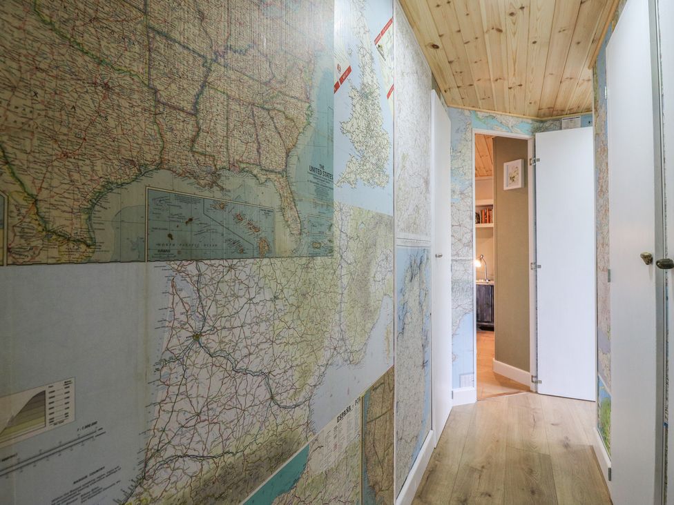 A hallway with map-covered walls at Orchard Lodge in Dover
