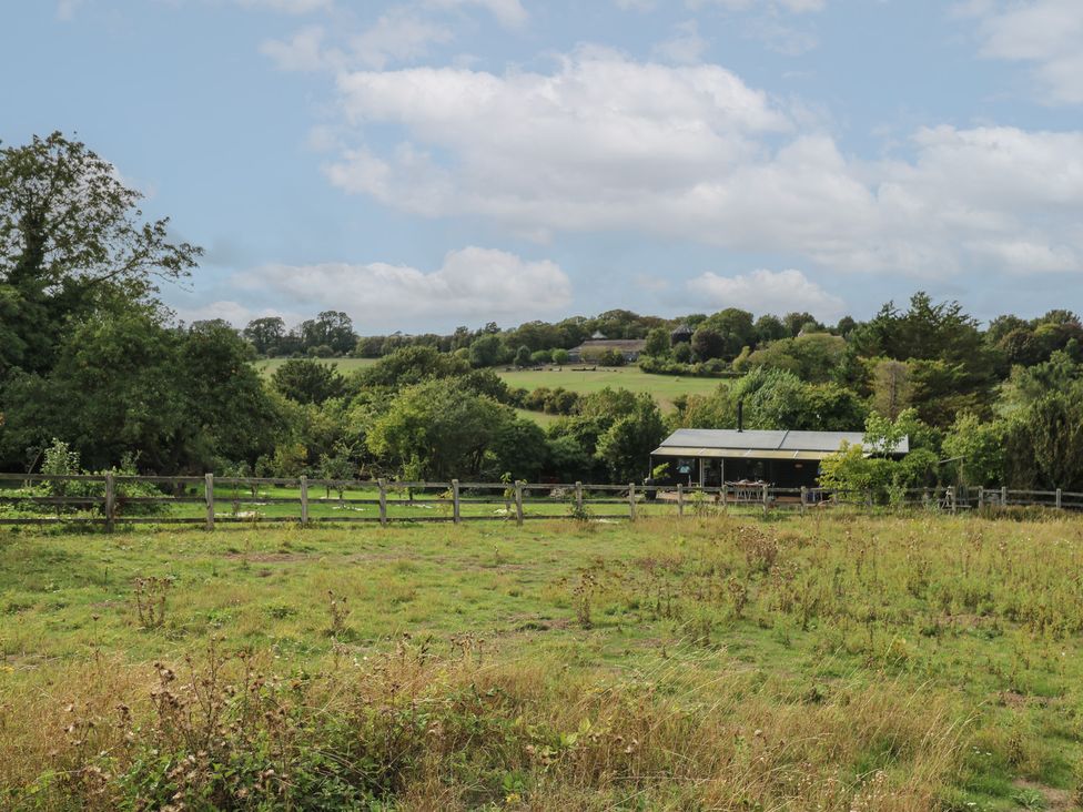 An outdoor scene with a house and trees at Orchard Lodge in Dover