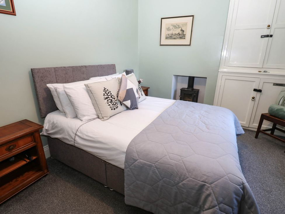 A bedroom with a bed and bedside furniture at Prudhoe Cottage Prudhoe