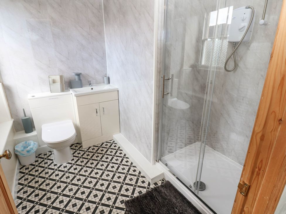 A bathroom featuring a toilet, sink, and shower at Prudhoe Cottage in Prudhoe