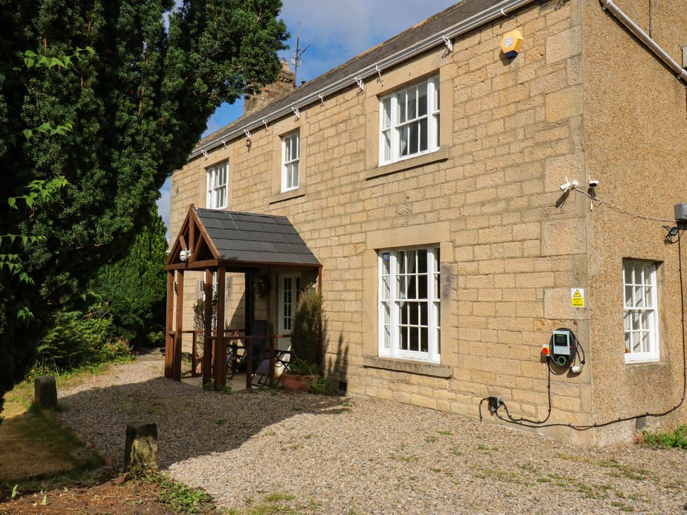 A house with a porch and driveway at Prudhoe Cottage in Prudhoe