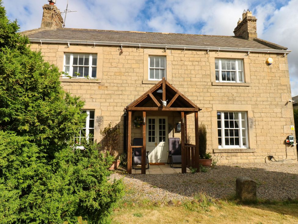 A house with a porch and garden at Prudhoe Cottage in Prudhoe
