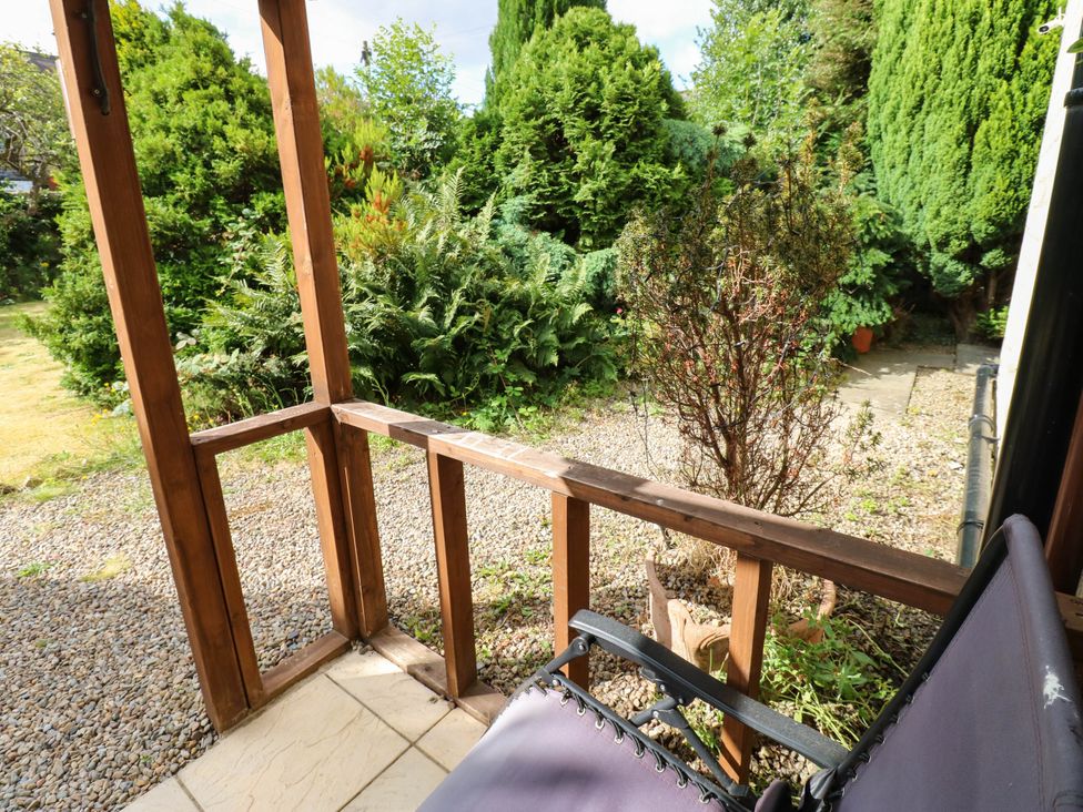 A garden view with plants and a chair at Prudhoe Cottage in Prudhoe
