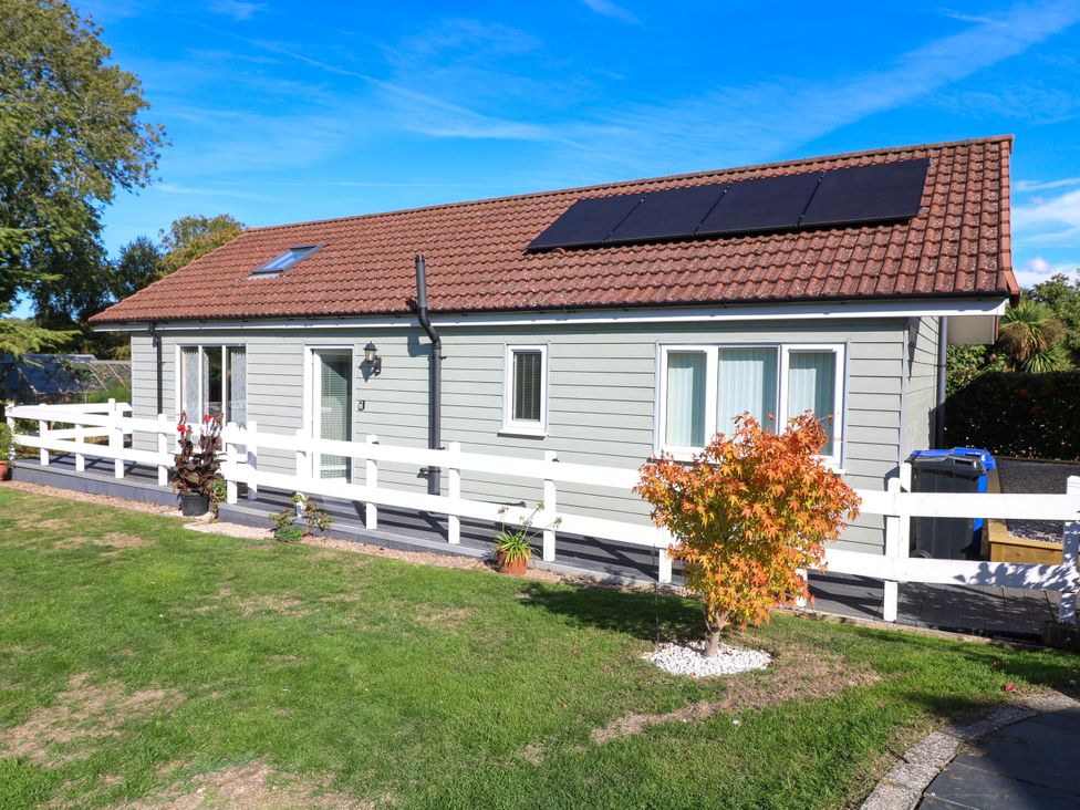 A house with solar panels in a garden at Jasper Lodge in Welton