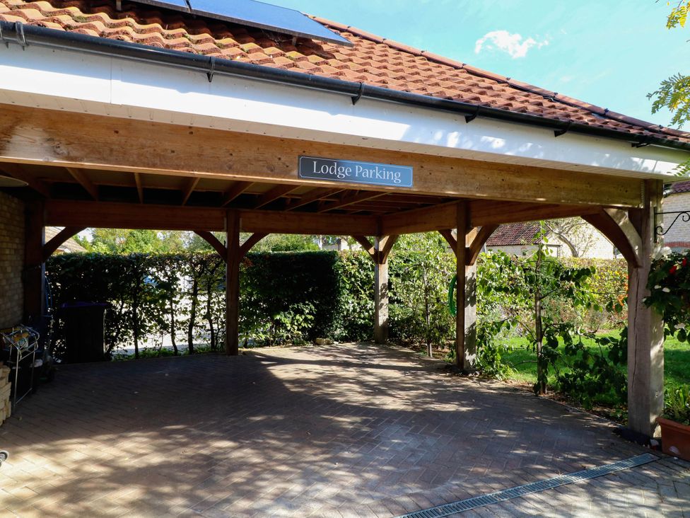 A carport with a sign reading Lodge Parking at Jasper Lodge in Welton