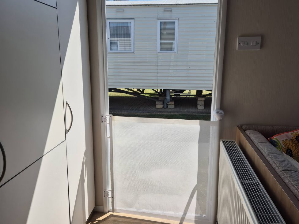 A living room with a door to the outside at 67 Harley Mead St Leonards-On-Sea