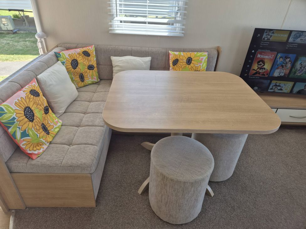 A living room with a sofa and table at 67 Harley Mead St Leonards-On-Sea