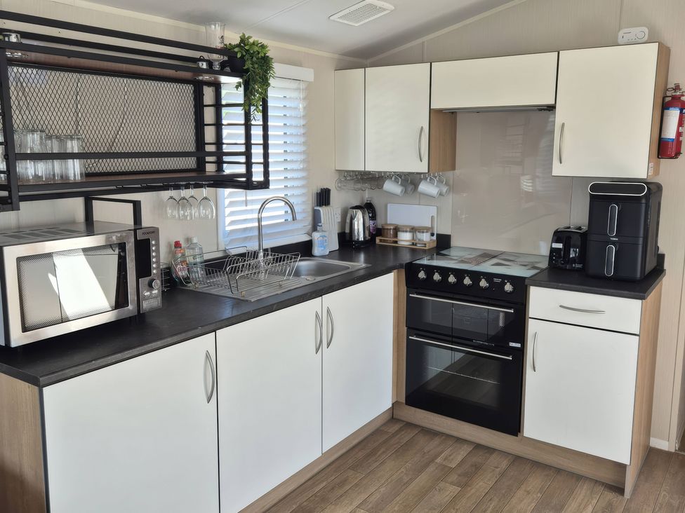 A kitchen with appliances and storage at 67 Harley Mead St Leonards-On-Sea