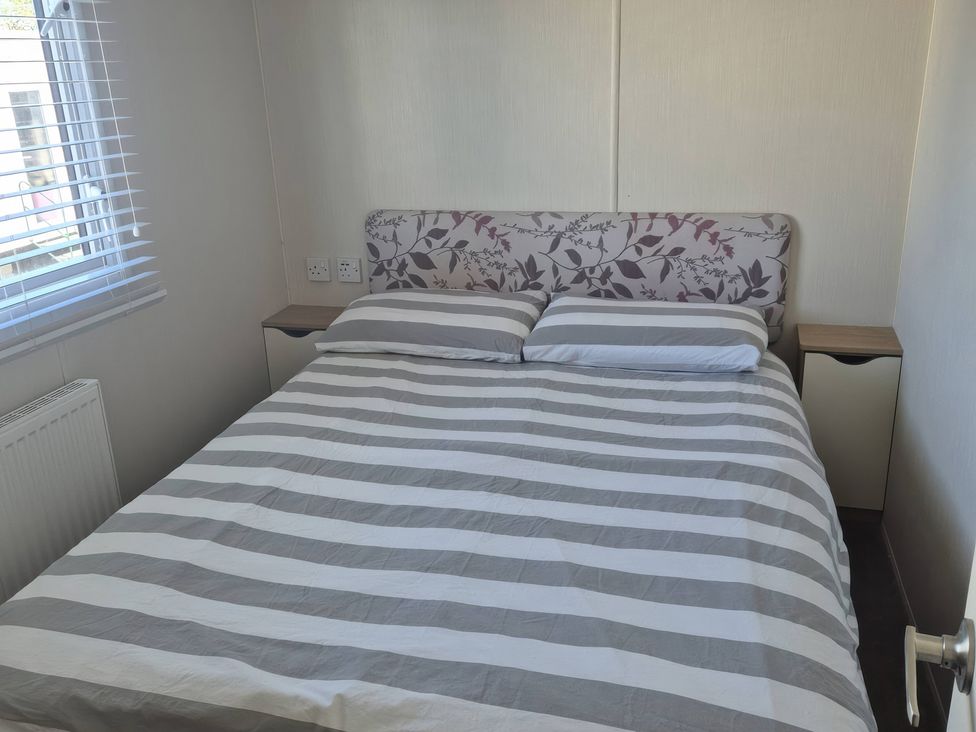 A bedroom with a bed and bedside table at 67 Harley Mead St Leonards-On-Sea