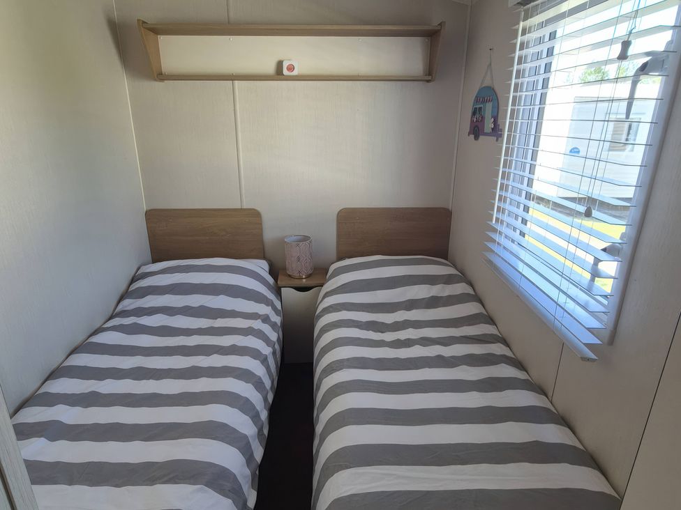 A bedroom with two single beds and a window at 67 Harley Mead St Leonards-On-Sea