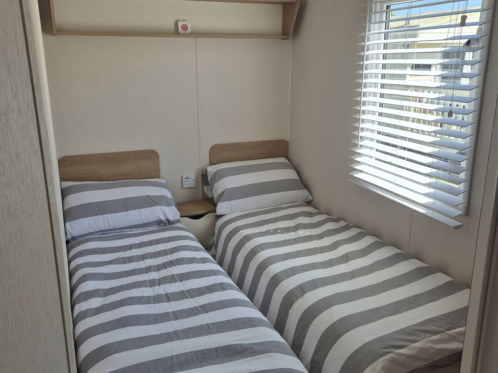 A bedroom with two single beds at 67 Harley Mead St Leonards-On-Sea