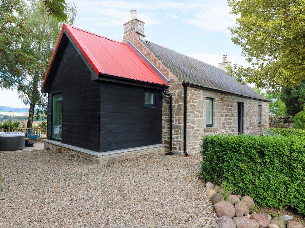 A cottage with a red roof and stone exterior at Doocot Wood Cottage Forfar