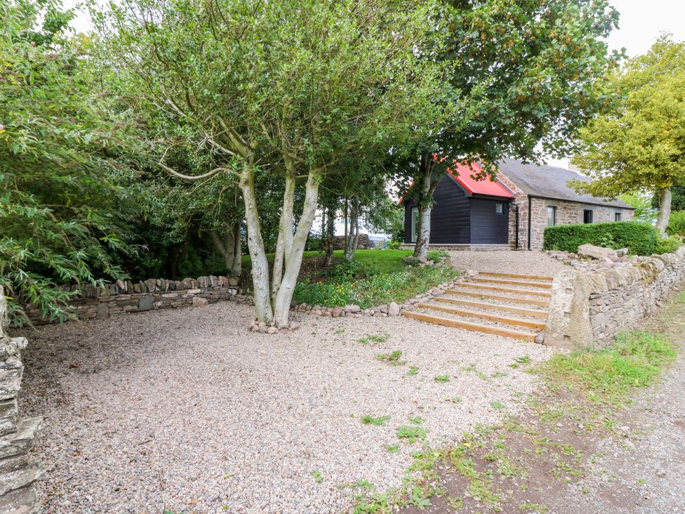 An outdoor area with a gravel path and steps at Doocot Wood Cottage Forfar