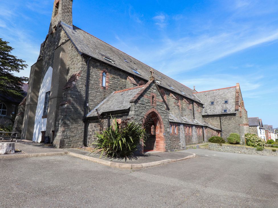 An outdoor view of a stone building with an entrance at Flat 16 Criccieth