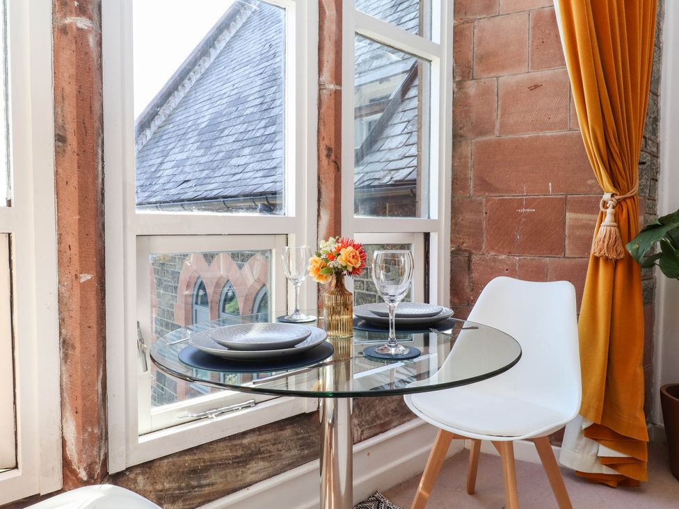 A dining area with a table and chairs at Flat 16 in Criccieth
