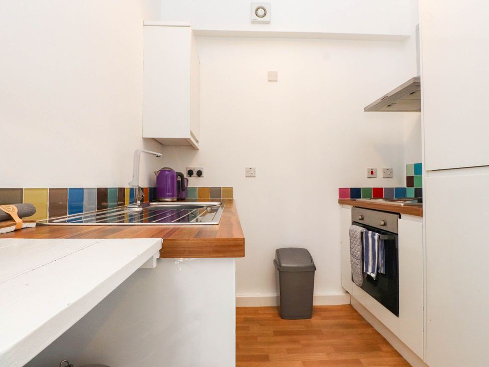 A kitchen with a sink and kettle at Flat 16 Criccieth