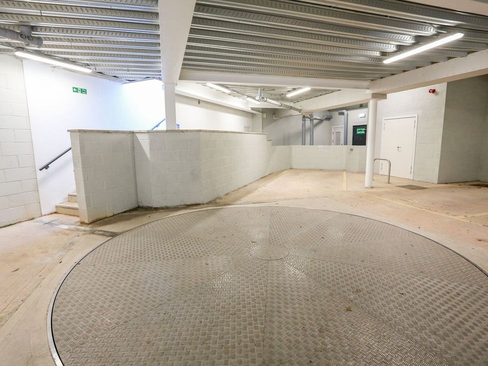 A parking area with a turntable and walls at Beachstone in Salcombe