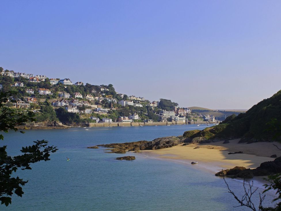 A view of houses on a hill by the river at Beachstone in Salcombe