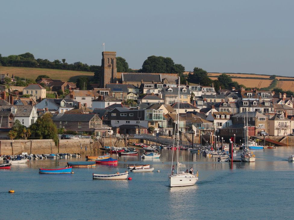 A view of a harbor with boats and buildings at Beachstone in Salcombe