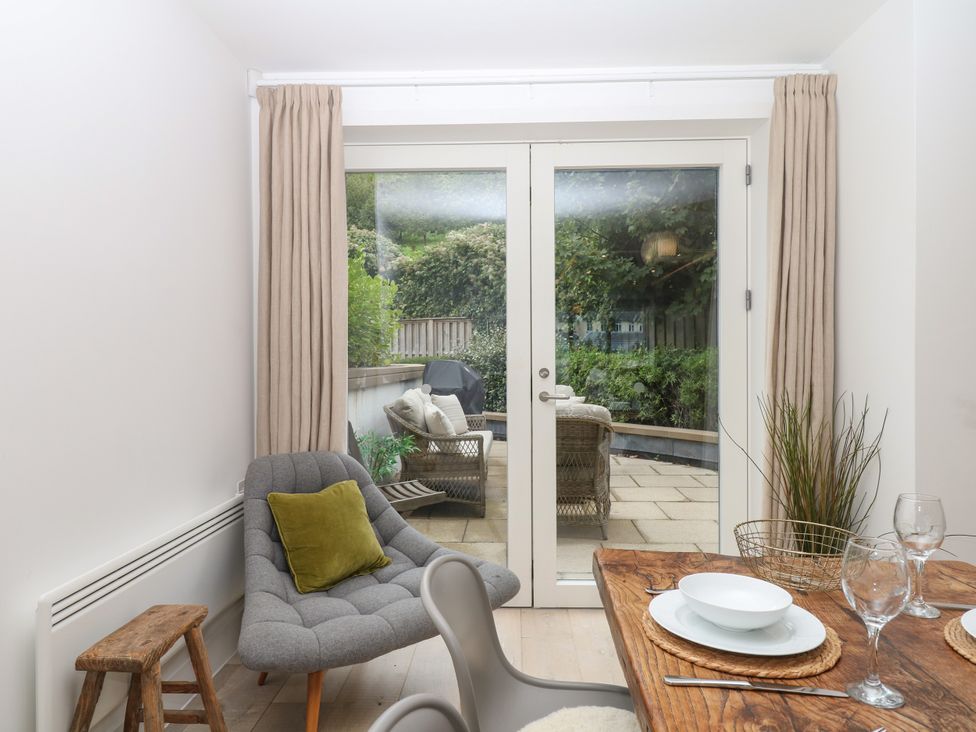 A dining room with a table and chairs at Beachstone in Salcombe