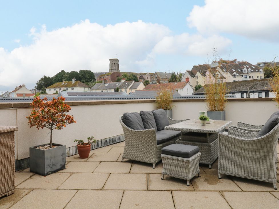 An outdoor space with furniture and plants at Beachstone in Salcombe