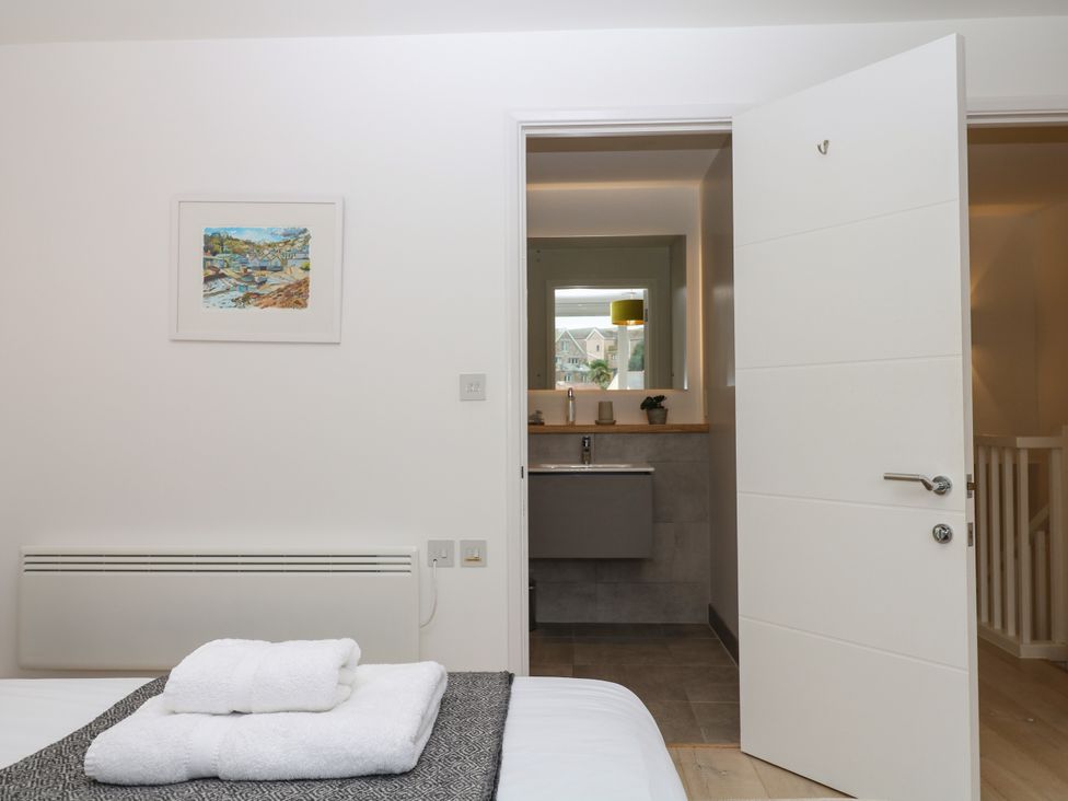 A bedroom with a view of a bathroom at Beachstone in Salcombe