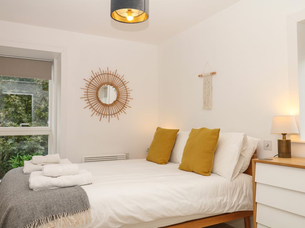 A bedroom with a bed and pillows at Beachstone in Salcombe