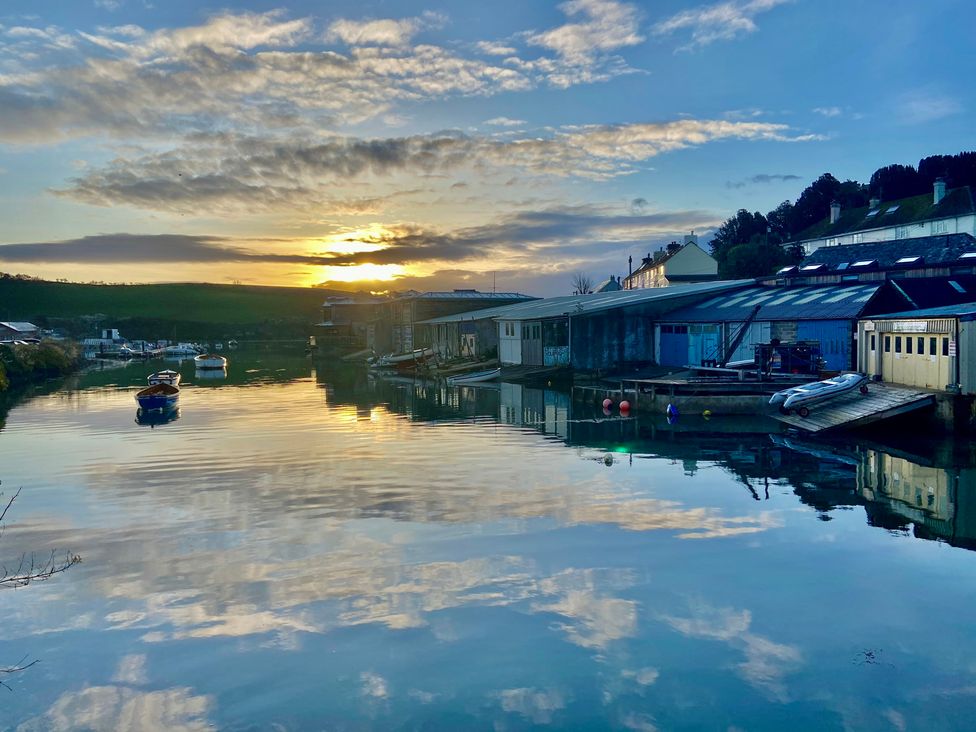 A view of boats and buildings reflecting on water at Beachstone in Salcombe