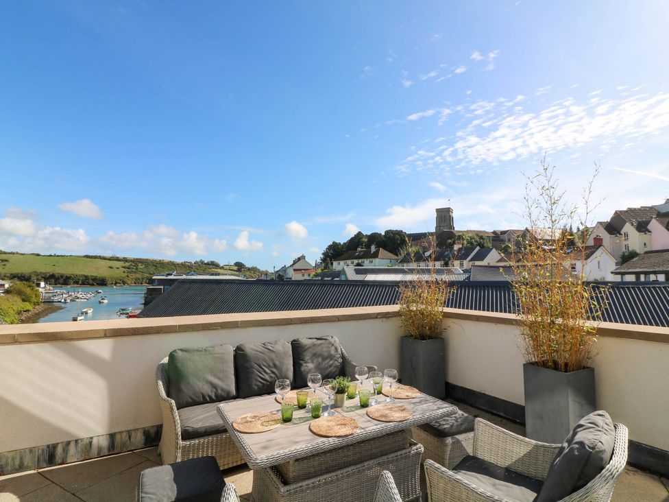 An outdoor terrace with furniture and a view at Beachstone in Salcombe