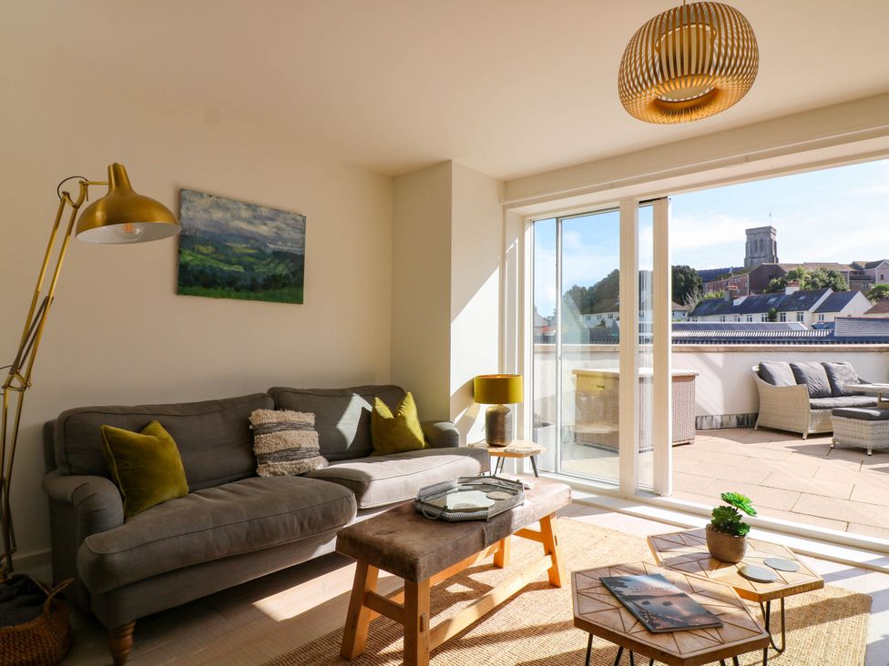 A living room with a sofa and coffee table at Beachstone in Salcombe