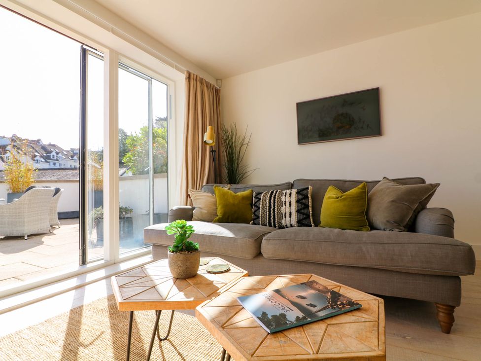 A living room with a sofa and coffee table at Beachstone in Salcombe