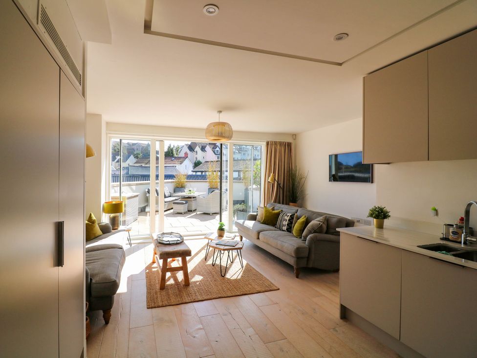 A living room with a sofa and coffee table at Beachstone in Salcombe